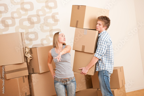 Moving house: Man and woman with box