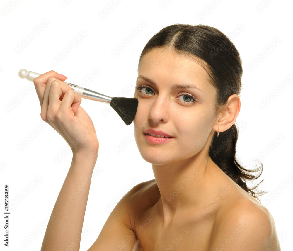 The pretty woman with a brush for a makeup The pretty woman with a brush for a makeup