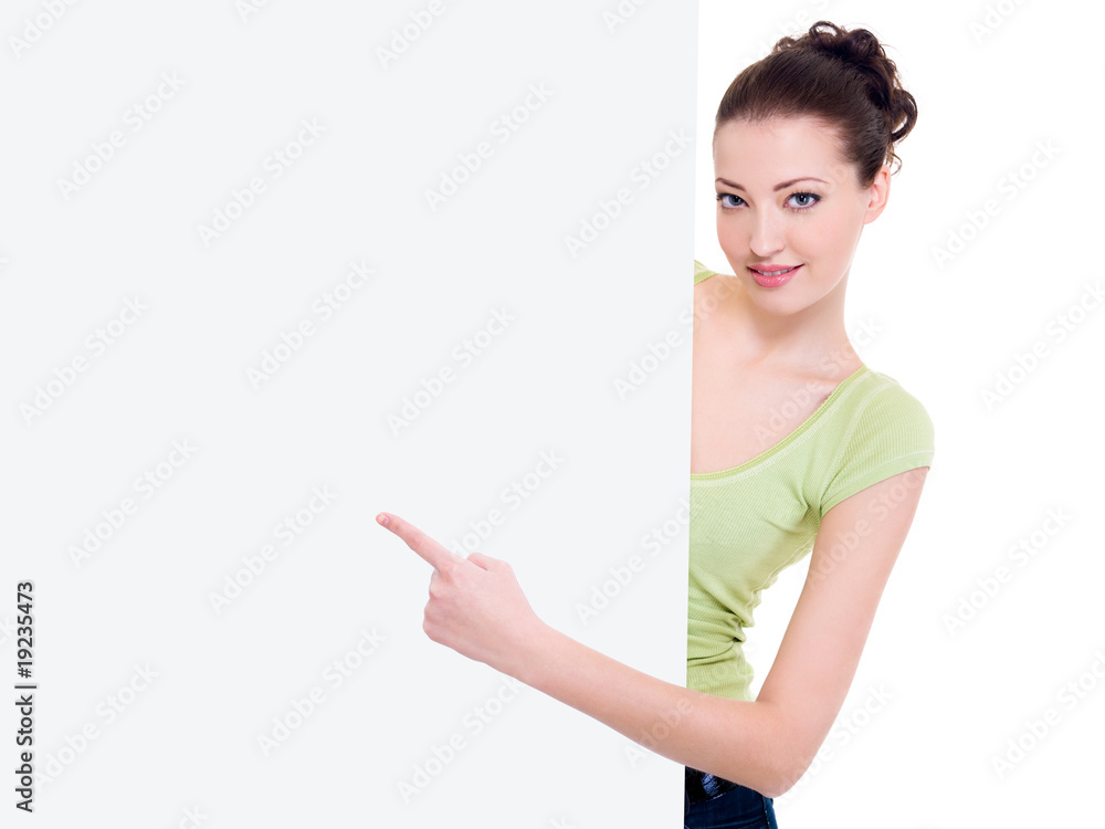 Beautiful smiling female points on the blank banner Beautiful smiling female points on the blank banner