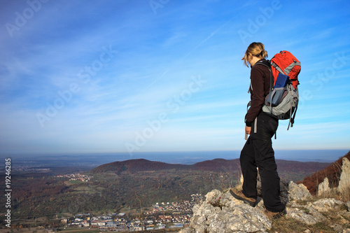 female Hiker is looking over the city photo