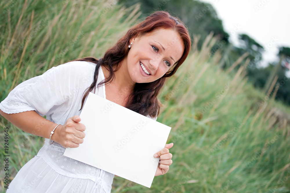 Happy young woman with blank sign Happy young woman with blank sign