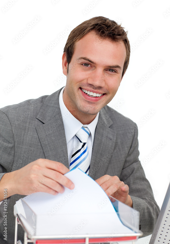 Confident young businessman studying a contract Confident young businessman studying a contract