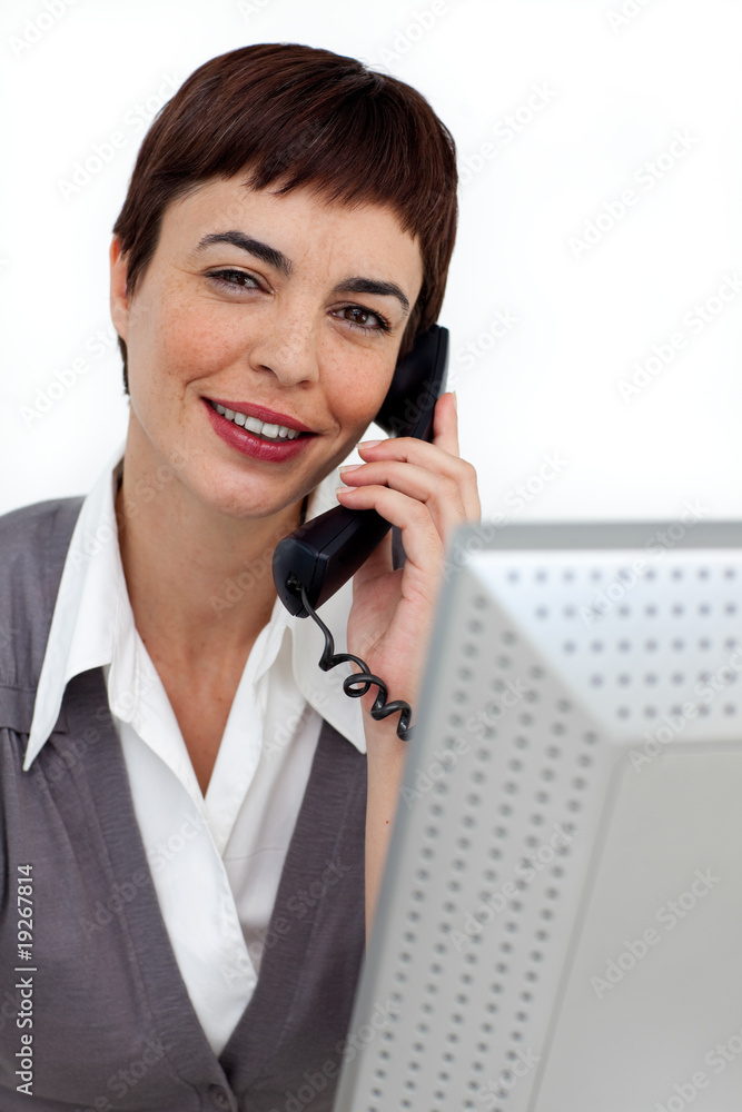 Assertive Businesswoman on phone at her desk Assertive Businesswoman on phone at her desk