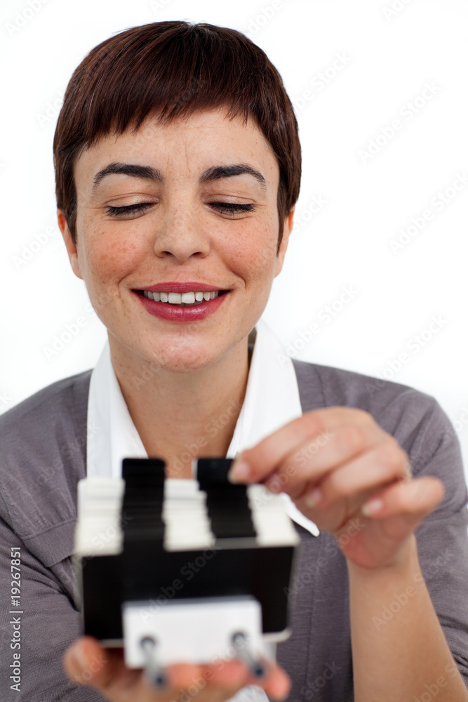 Confident businesswoman consulting a business card holder Confident businesswoman consulting a business card holder