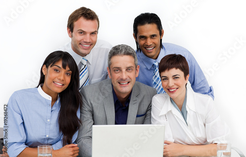 Multi-ethnic business group using a laptop