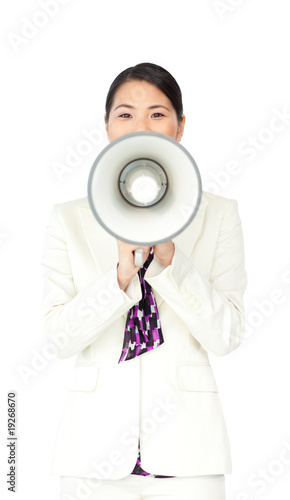 Attractive businesswoman yelling through a megaphone