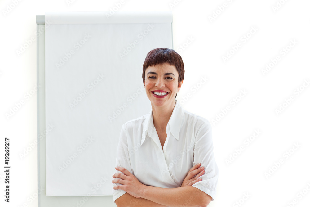 Laughing businesswoman with folded arms in front of a board Laughing businesswoman with folded arms in front of a board