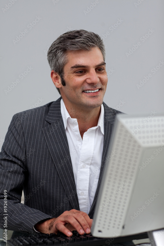 Mature male executive working at a computer Mature male executive working at a computer