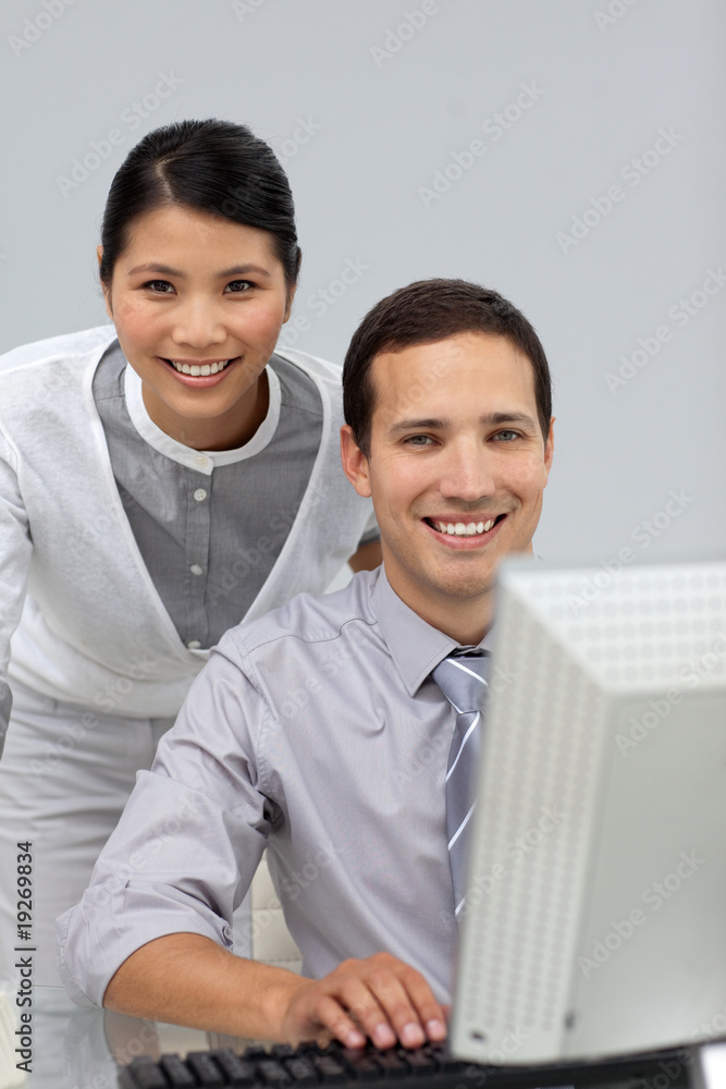Assertive Asian businesswoman helping her colleague Assertive Asian businesswoman helping her colleague