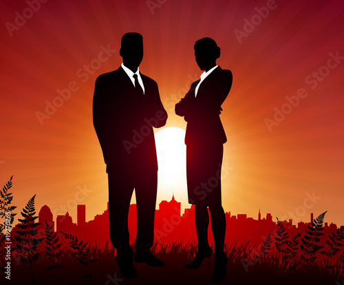 Businessman and Businesswoman on sunset background