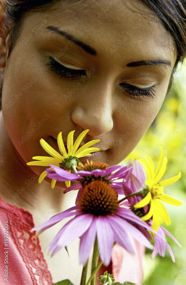 Woman holding flowers in garden Woman holding flowers in garden