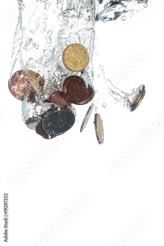 Coins falling into clear water