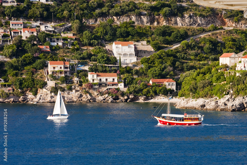 Obraz premium White Sailboat and Red Ferry