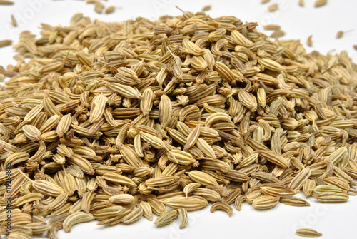 some organic caraway seed and a white background