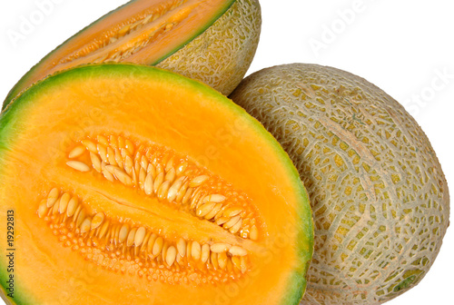 Fresh ripe melons and slices of it, showing pulp and seeds.