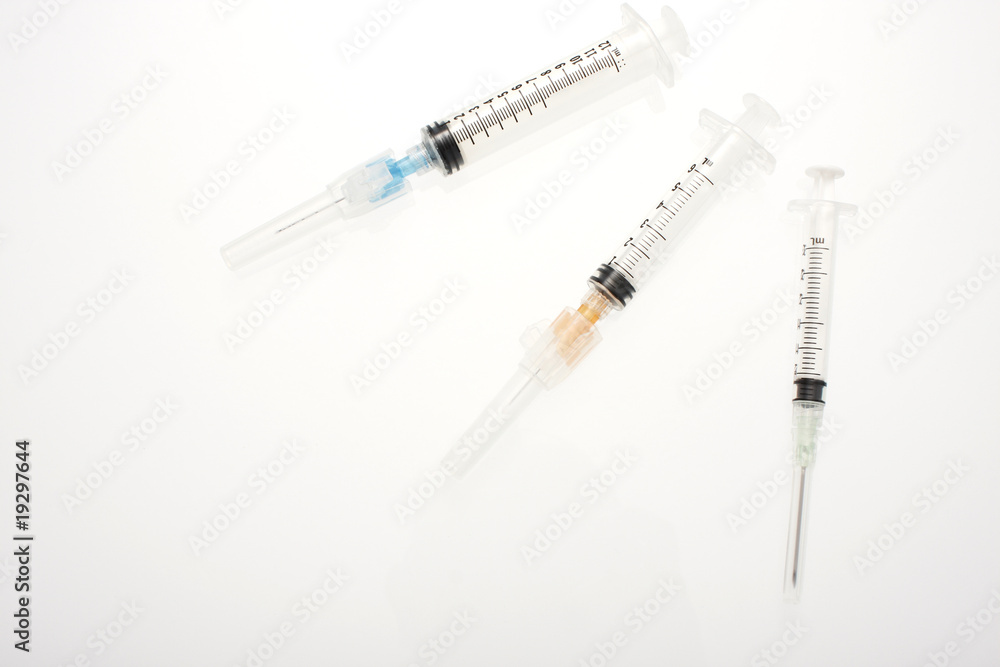 Assorted syringes on a table. Assorted syringes on a table.