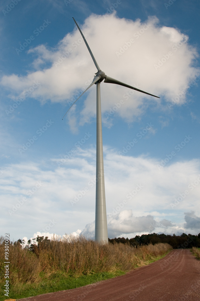 wind turbine next to dirt track