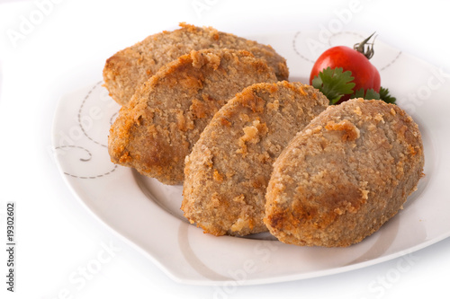 Cutlet with parsley and tomato