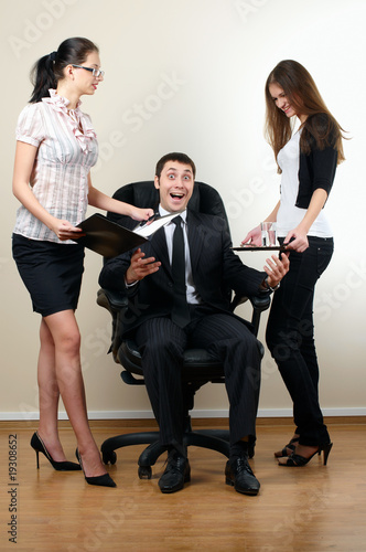 young businessman sit in armchair with collegues