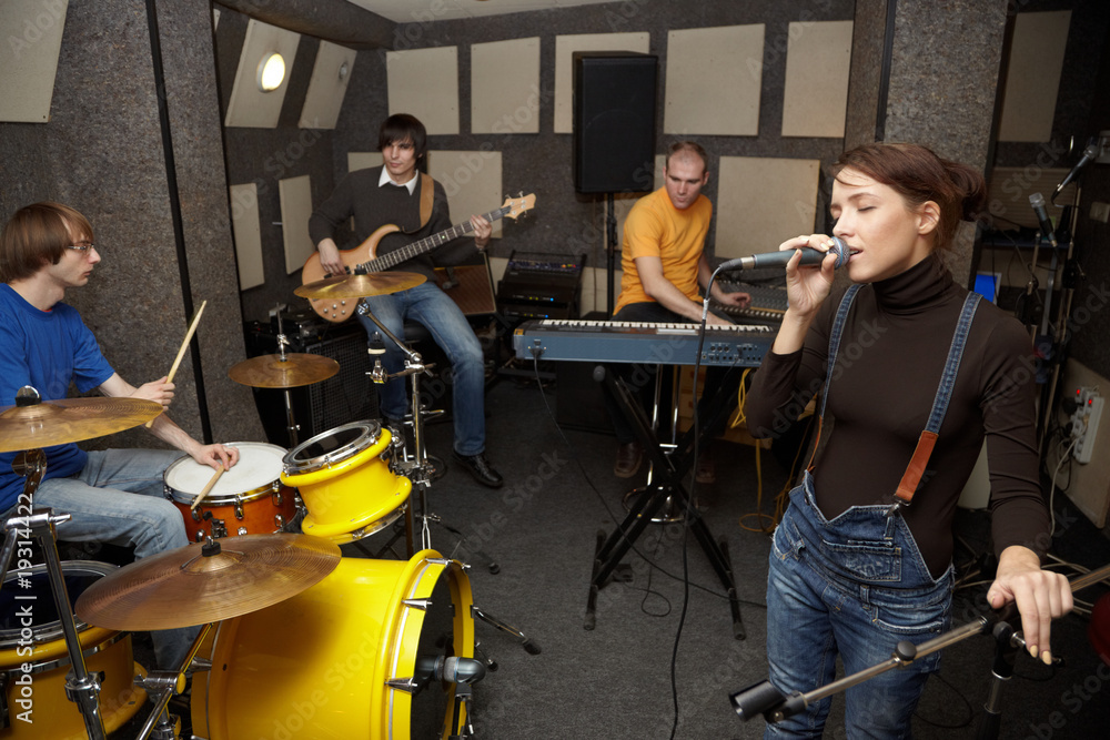 Naklejka premium rock band working in studio. focus on clothers of vocalist