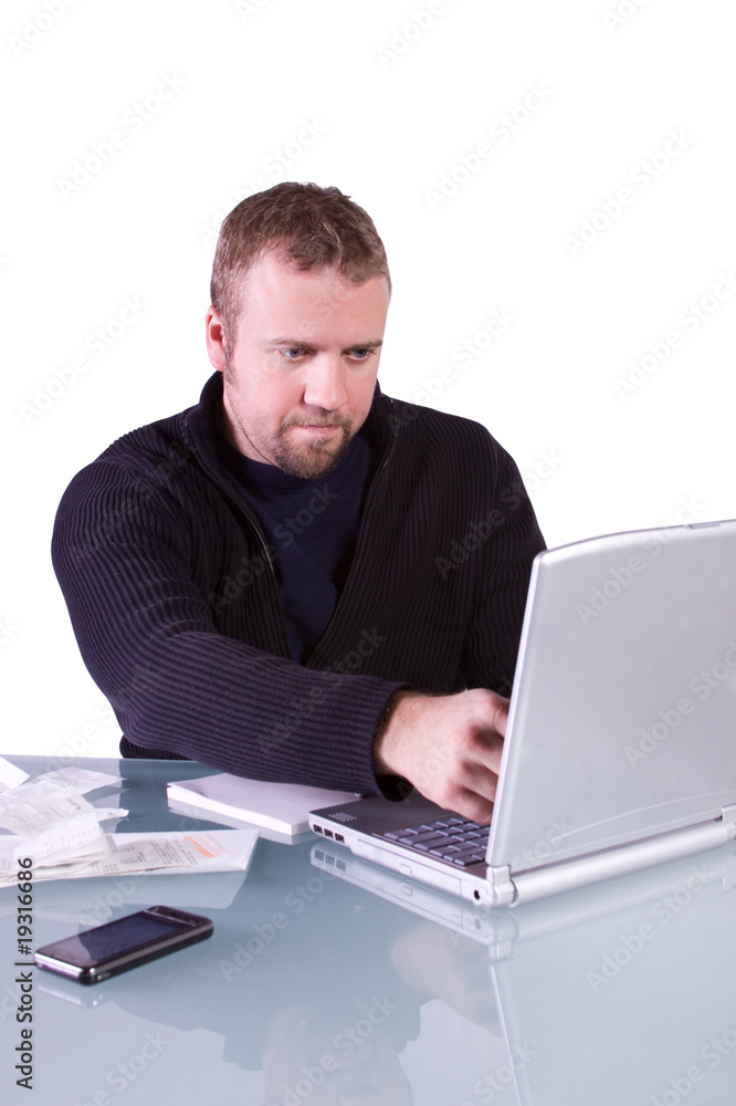 Young Casual Businessman Working at his Desk Young Casual Businessman Working at his Desk
