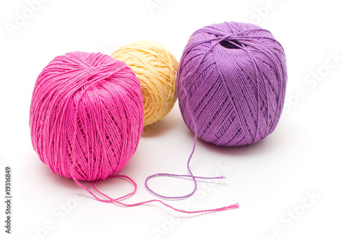 Three reels of yarn of different colors isolated on white
