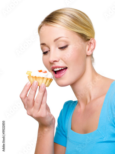 young woman eats the sweet cake