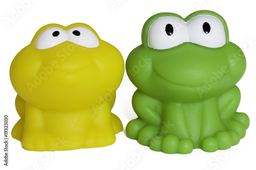 toy rubber frogs on white background