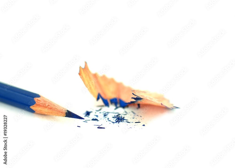 Single blue pencil with pencil sharpening shavings