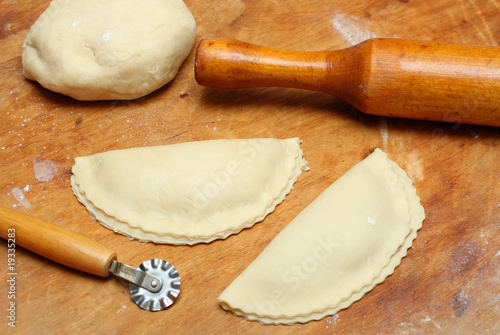 rolling-pin with patty and pastry photo