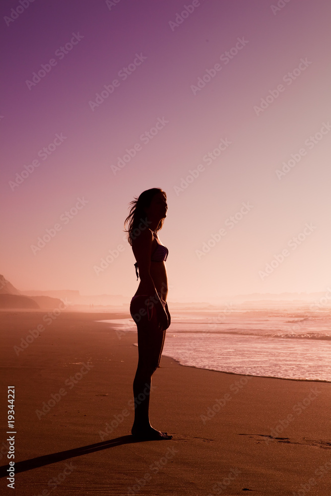 Woman silhouette on the beach
