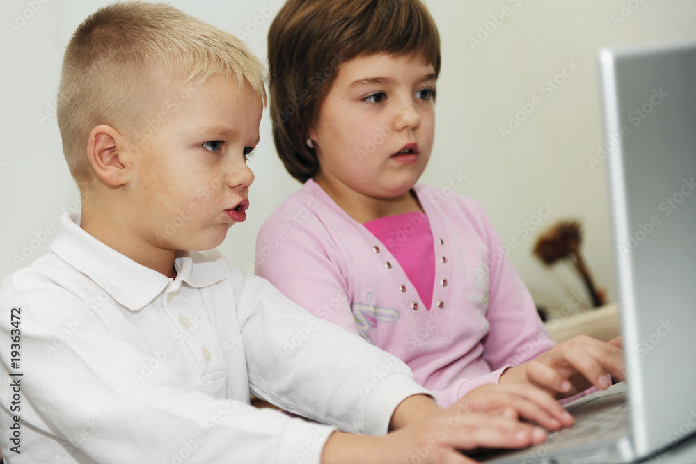 childrens have fun and playing games on laptop computer childrens have fun and playing games on laptop computer
