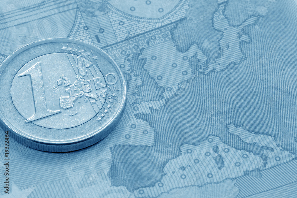 Fototapeta premium Euro coin on euro banknote (blue toned)