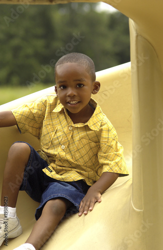 African American boy on slide