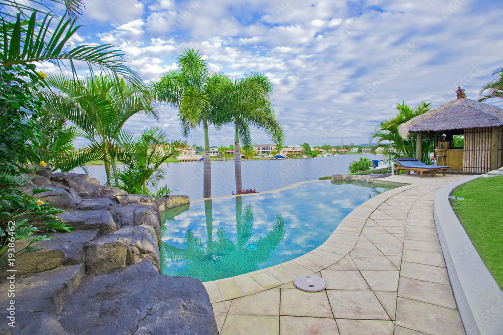 Fototapeta premium Waterfront Mansion with Pool and Bali hut overlooking the canal