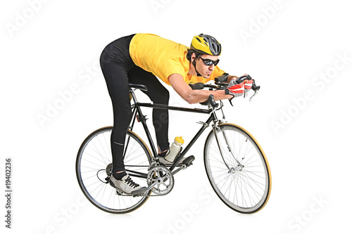 Fototapeta Naklejka Na Ścianę i Meble -  Young man wearing a yellow shirt riding a bicycle