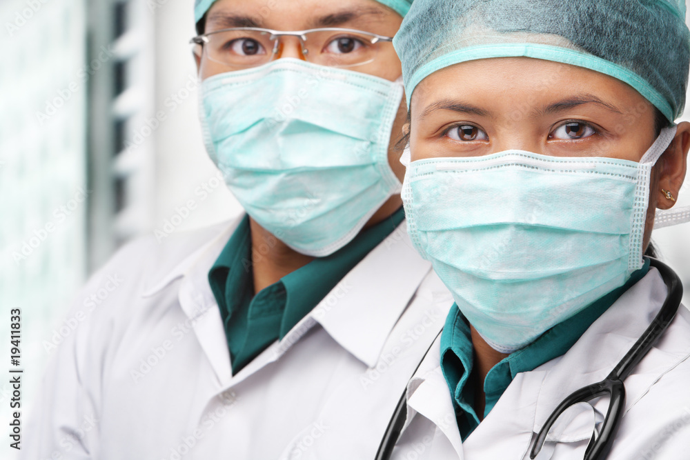 Two Asian surgeon posing to camera Two Asian surgeon posing to camera