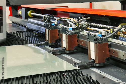 close up of cnc punching machine with metal sheet