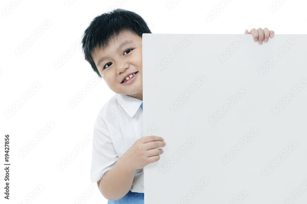 Portrait of an elementary schoolboy holding a billboard Portrait of an elementary schoolboy holding a billboard