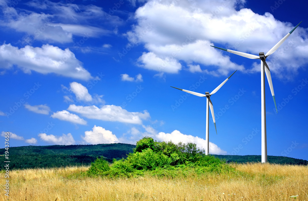 Wind turbines on cloudy sky