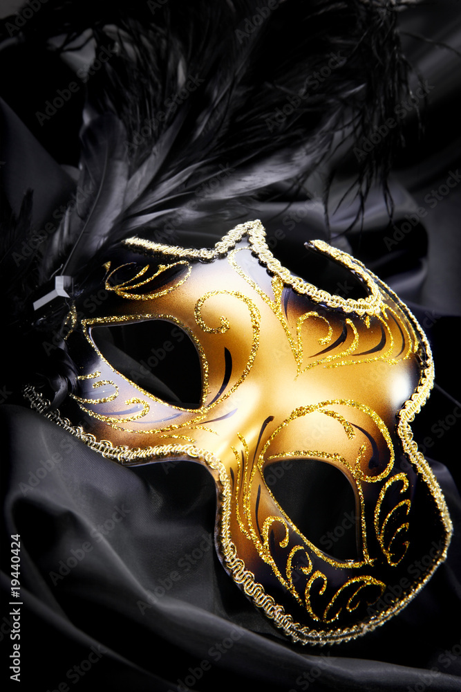 Carnival mask on black silk background