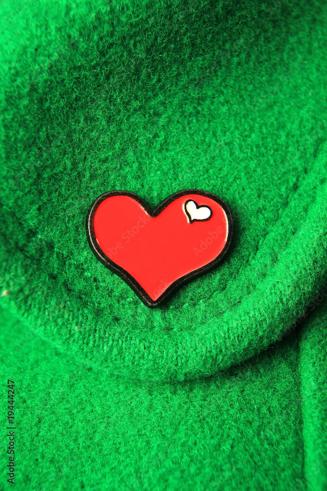 Fototapeta premium Heart on green fabric.