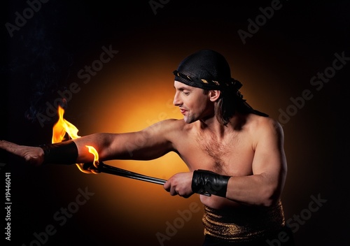 Handsome men performing fire show