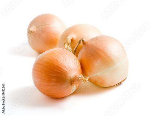 Four yellow onion bulbs