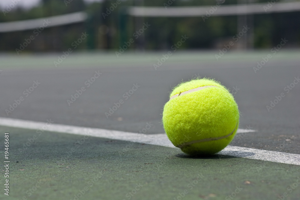 Closeup of tennis ball on base line
