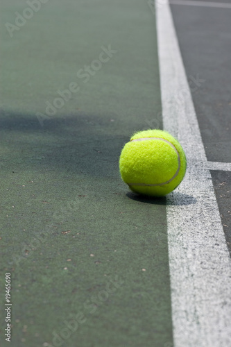 Tennis ball just beyond the base line