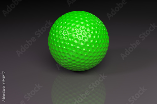 Green golfball on gray slightly reflective background