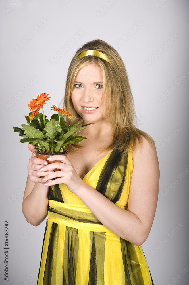 Young sexy summer woman with orange daisy flowers in pot Young sexy summer woman with orange daisy flowers in pot