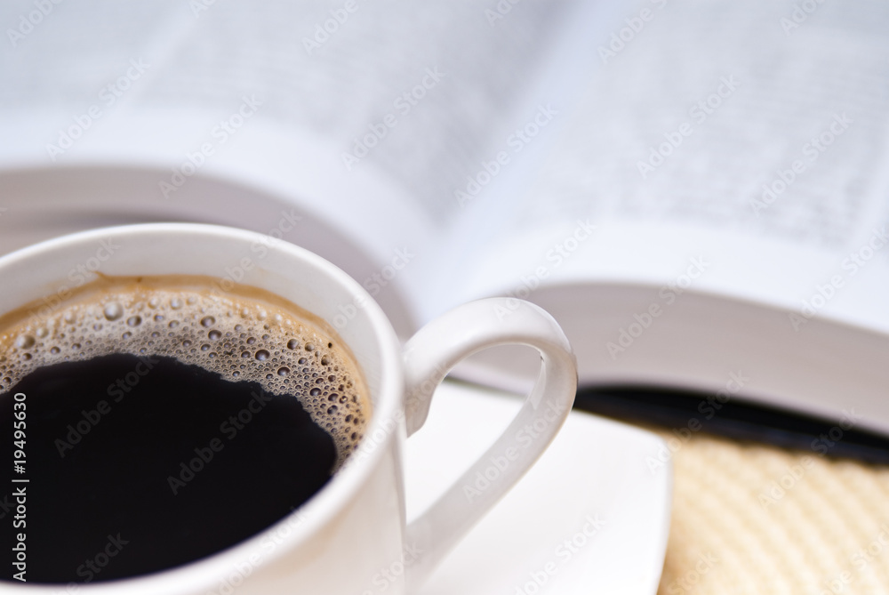 cup of coffe and opened book cup of coffe and opened book