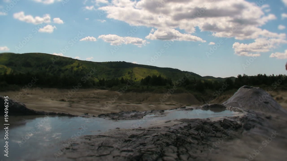 Mud volcano and fluffy clouds Mud volcano and fluffy clouds
